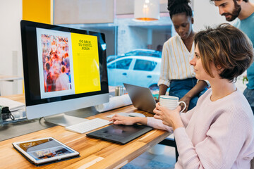 Focused diverse coworkers working on design together