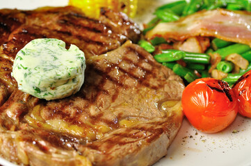 Steak with grilled vegetables closeup view