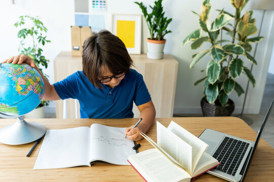 kid sitting on desk studying 