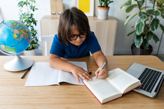 kid sitting on desk studying 