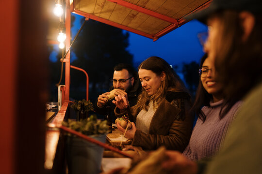 Friends Eating At A Foodtruck