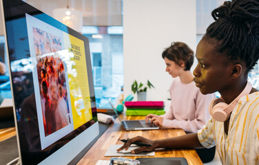 Diverse colleagues working on modern gadgets in office