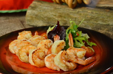 fried roasted shrimps in plate with wegetables