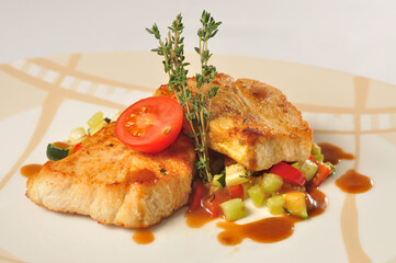 Meat steak with vegetables on white plate closeup