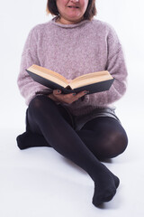 Unrecognizable woman sitting with a blue open book. Copy space