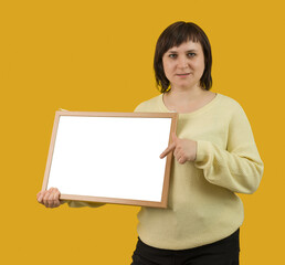 woman holding white board on yellow background