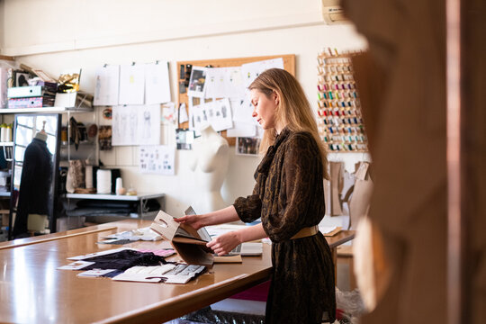Woman fashion designer working in her sewing atelier