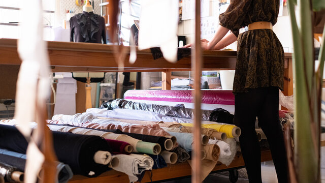 Anonymous woman fashion designer working in her sewing atelier