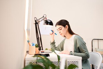 Intelligent woman reading at desk.