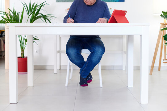 Mature man painting with an online tutorial
