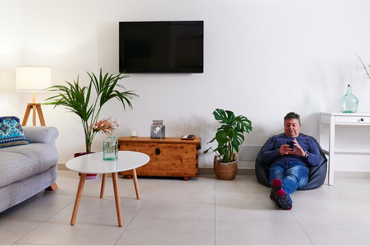 Mature man reading a text at home