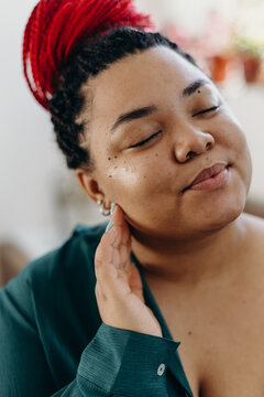Content black woman touching smooth face