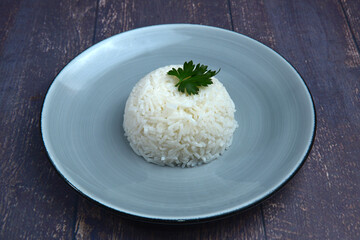 white rice is ready to eat on a plate,dark wooden table
