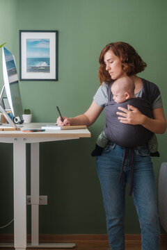 Woman With A Baby Working From Home
