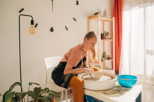 Woman working in her pottery home studio