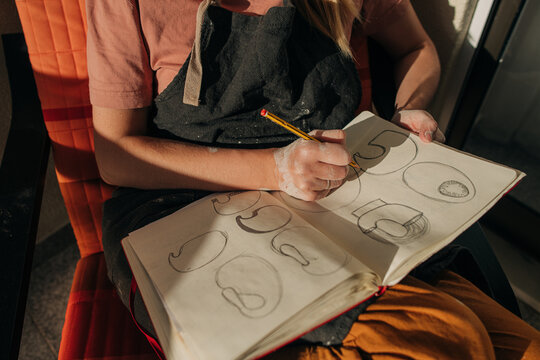 Female potter making sketches