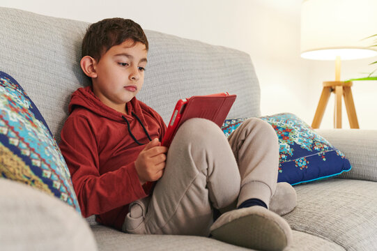 Little boy watching something on a tablet 