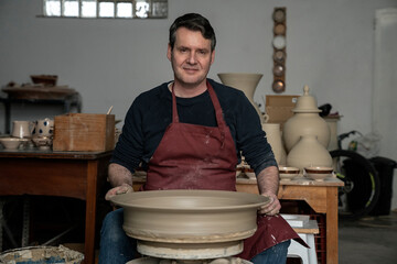 Artisan facing the camera in a workshop