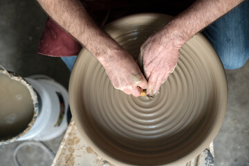 Aerial photo of hands using a lathe in a workshop