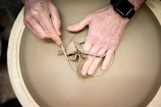 Aerial photo of the hands of a person filing the surface of a ce