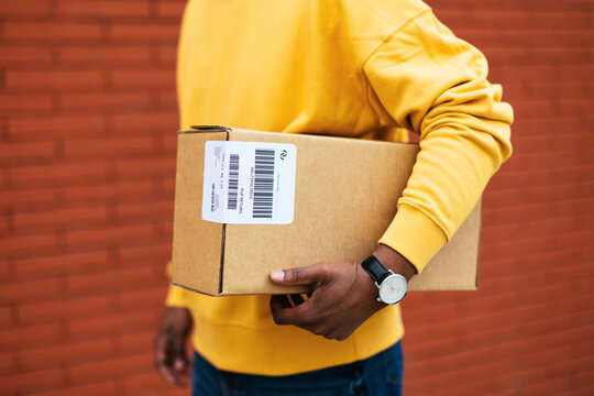 Crop courier with carton box in street