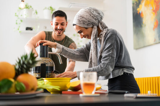 Muslim couple preparing fresh juice at home