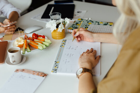 Woman Filling In The Timetable 
