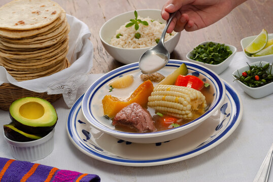 (Caldo de res)  traditional Guatemalan dish served with rice, vegetables, tortillas, and avocado.