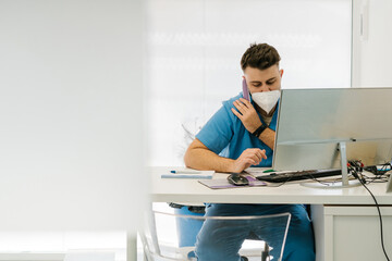 Veterinarian talking on the phone and writing in a notebook in t