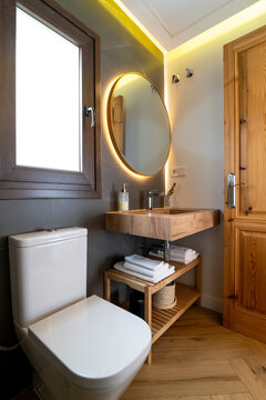 Shelves with toiletries near toilet and mirror