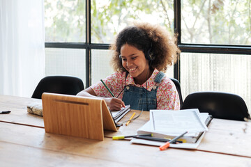 Smiling girl studying online at home