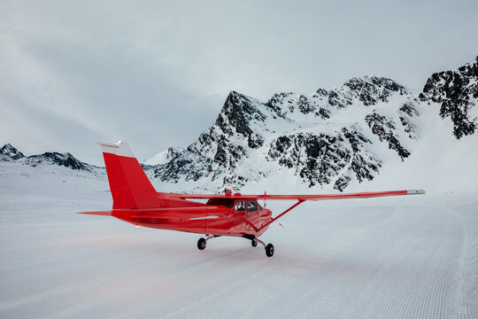 Red plane on the snow of some snowy mountains