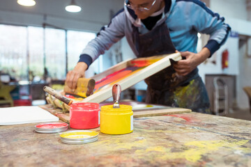 Paint on the table and artist working