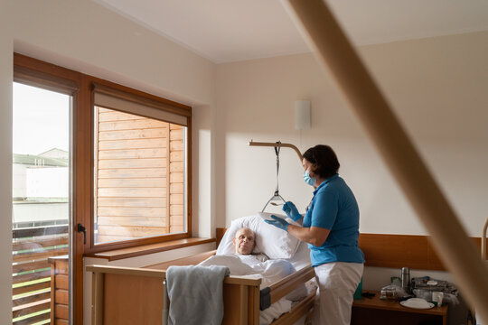 Hospital Worker Feeding Patient