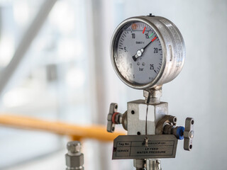 Pressure gauge of measuring instrument close up in industry zone at power plant with closed up