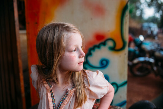 Portrait of a young girl with freckles in a tropical setting