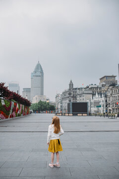 A little girl stands on the Bund in Shanghai, China