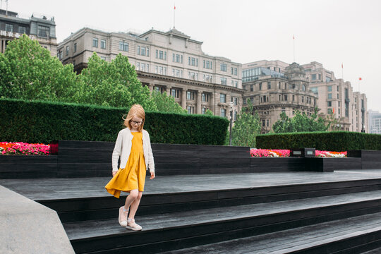 A little girl walking down steps on the Bund in Shanghai