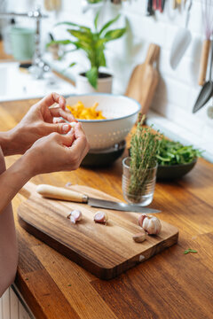 Woman cleaning fresh garlic cloves