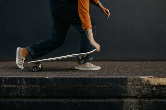 Young woman riding skateboard