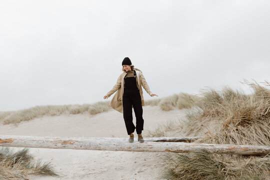Trendy Young Woman Walking on Log