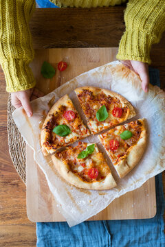 Woman cooking homemade Pizza Margherita