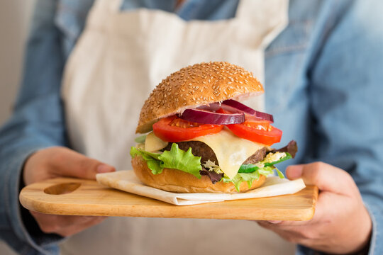 Woman holding a grilled hanburger