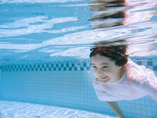Child swims in T-Shirt