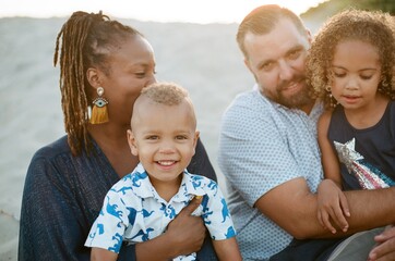 Portrait of biracial family on beach