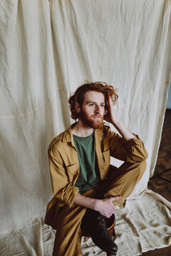 
spoils red-haired bearded guy sitting on a chair