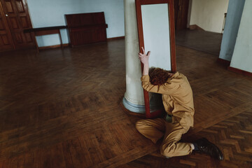 
portrait of a young red-haired man by the mirror