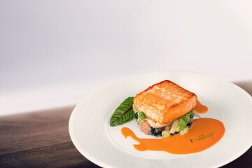 Freshly cooked salmon fillet on a white plate