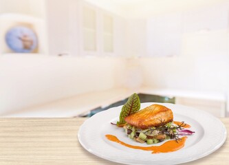 Freshly cooked salmon fillet on a white plate