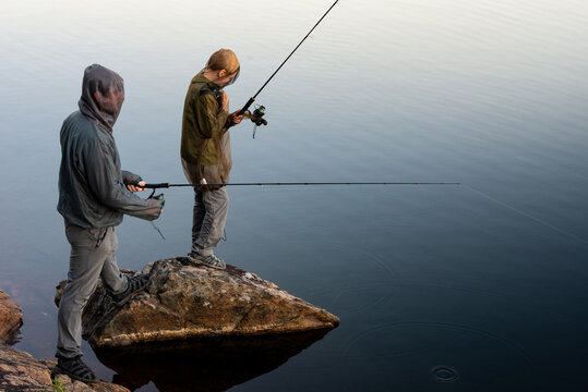 Father and Son Fishing at Lake with Bug Jackets on Back Country Family Canoe Trip